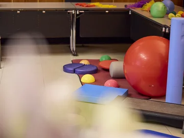 Ein Gymnasikball und andere bunte Sportgeräte von der Mitmachaktion Sportlich aktiv bei PHKA im Rathaus.